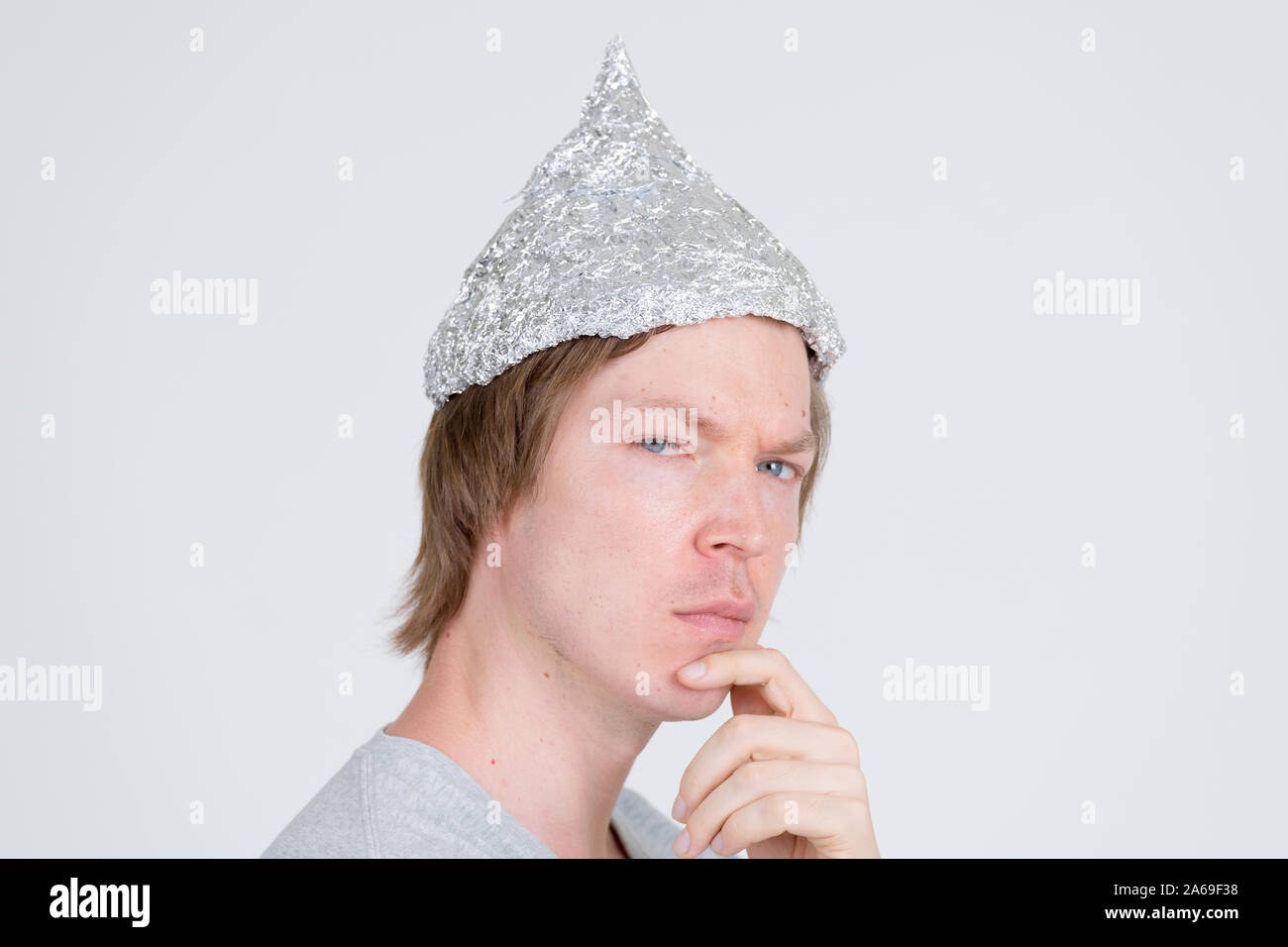 closeup-profile-view-of-young-man-with-tinfoil-hat-thinking-and-looking-at-camera-2A69F38.jpg