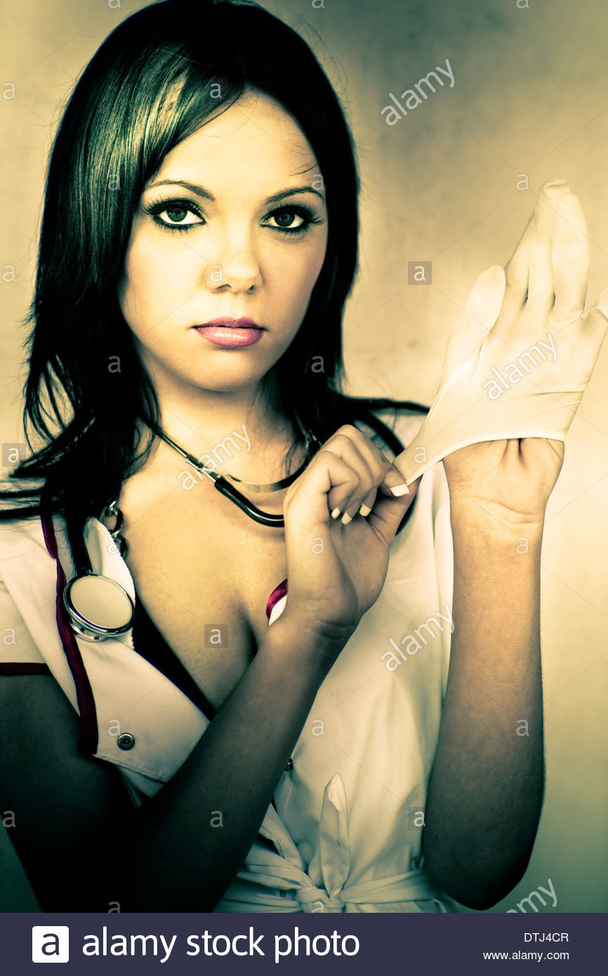 a-healthcare-nurse-provocatively-puts-on-rubber-gloves-during-a-not-DTJ4CR.jpg