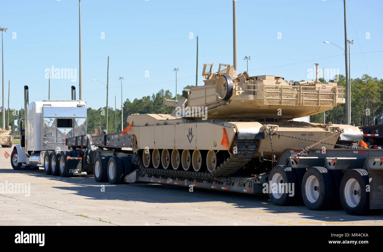 a-m1a2-abrams-main-battle-tank-from-company-b-2nd-battalion-7th-infantry-regiment-is-loaded-onto-a-trailer-at-the-rail-marshaling-area-at-fort-stewart-georgia-may-2-the-mechanized-company-team-will-be-supporting-the-3rd-infantry-brigade-combat-team-10th-mountain-division-during-their-rotation-at-the-joint-readiness-training-center-at-fort-polk-louisiana-may-8-25-MR4CKA.jpg